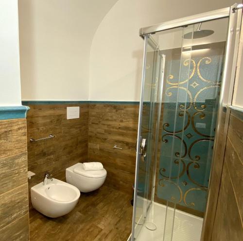 a bathroom with a toilet and a sink and a shower at L'Ulivo Comfort Rooms in Terrasini