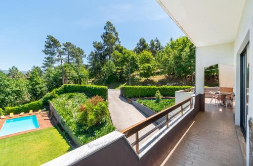 a balcony with a view of a garden and a swimming pool at Apartamentos Do Ermal in Vila Boa