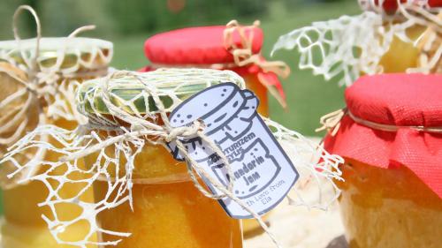 a bottle of honey with a tag on it at Agroturizem Bylis in Hekal