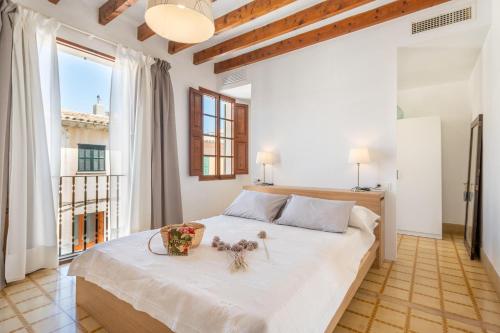 a bedroom with a large bed with a large window at Ca na Francesca in Pollença