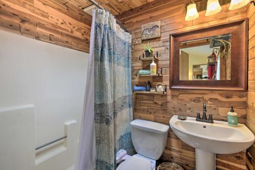 a bathroom with a toilet and a sink and a mirror at Peaceful Cabin on Horse Farm, 5 Mi to Town! in Port Townsend