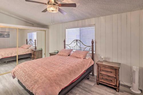 a bedroom with two beds and a ceiling fan at Riverfront Bullhead City Home with Private Dock in Bullhead City