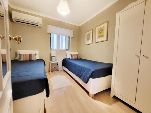 a small bedroom with two beds and a window at Lisbon Cottage Principe Real in Lisbon