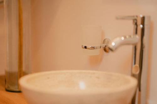a sink in a bathroom with a faucet at Hotel Fratelli in Aguascalientes