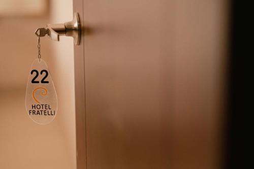 a door with a sign hanging from it at Hotel Fratelli in Aguascalientes