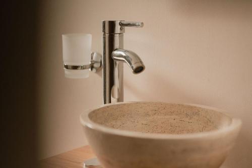 a sink with a faucet in a bathroom at Hotel Fratelli in Aguascalientes
