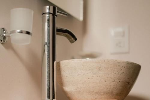 a sink with a faucet in a bathroom at Hotel Fratelli in Aguascalientes