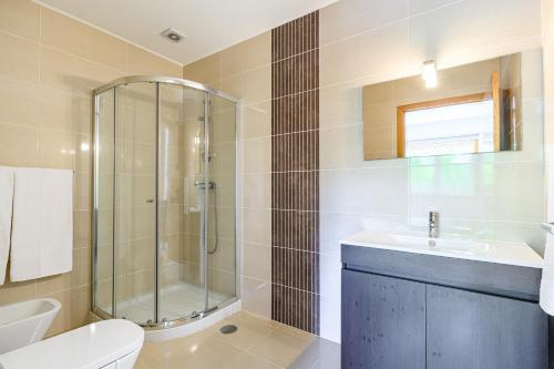 a bathroom with a shower and a toilet and a sink at Escolinha de France in France