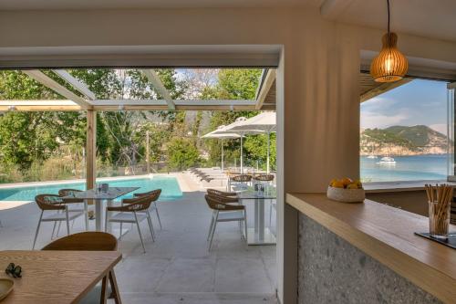 a kitchen and dining room with a view of a pool at Alboro seaside suites in Parga