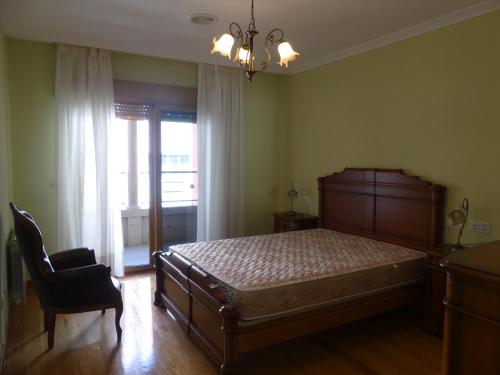 A bed or beds in a room at Apartamentos Villa Nustre