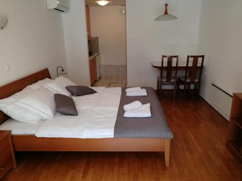 a bedroom with a bed with two towels on it at Apartmaji Z Fizine in Portorož