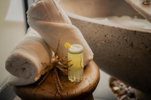 a person holding a glass jar filled with yellow liquid at Susana Balbo Winemaker´s House in Ciudad Lujan de Cuyo