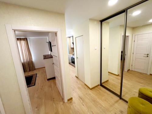 a living room with a sliding door and a mirror at M&M Apartment V SELF CHECK-IN in Panevėžys