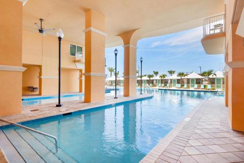 a swimming pool at a resort with blue water at Calypso 3-406 - Paradise by the Pier in Panama City Beach