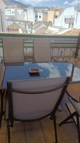 a table on a balcony with a view of a city at Ramón y Cajal in Estepona