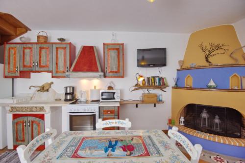 a kitchen with a table and a kitchen with a stove at Stella's traditional house. in Alonnisos Old Town