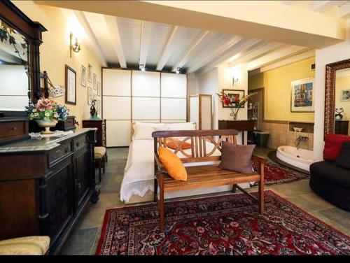 a large room with a bed and a bath tub at Villa dei Marchesi Carrozza in Santa Teresa di Riva