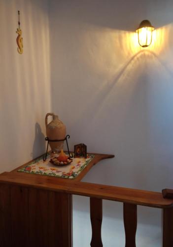a table with a lamp and a tea pot on it at Stella's traditional house. in Alonnisos Old Town