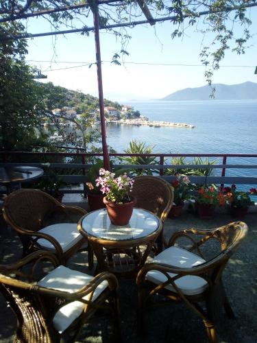 a table and chairs with a view of the ocean at Georgia's in Ayía Kiriakí