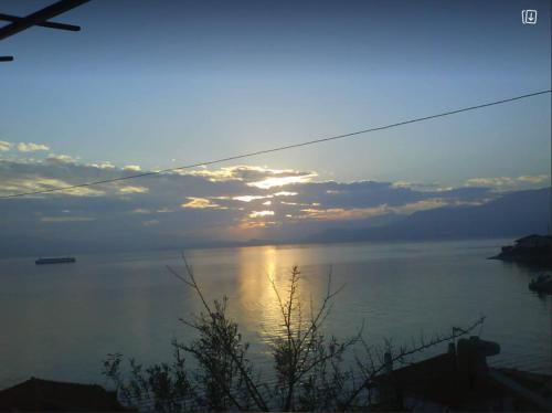 a sunset over a body of water with the sun setting at Georgia's in Ayía Kiriakí