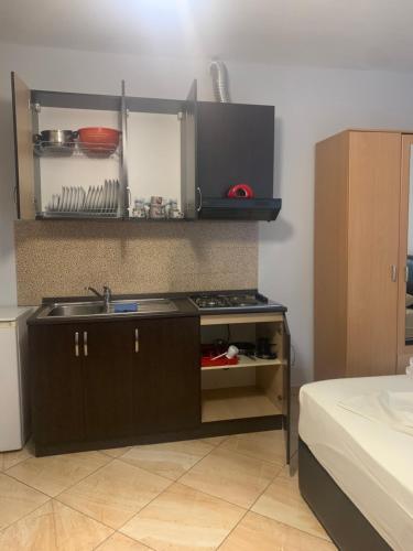 a kitchen with a sink and a stove at Kokomani in Durrës