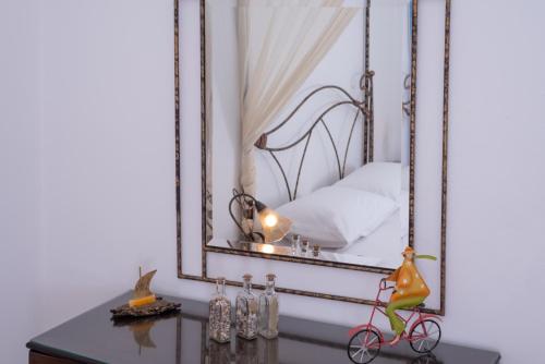 a mirror above a table with a bike on it at Haris Villas in Keratokampos