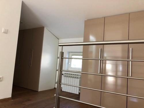 a kitchen with a stainless steel refrigerator in a room at Vila Danin with free garage,Stari grad in Sarajevo