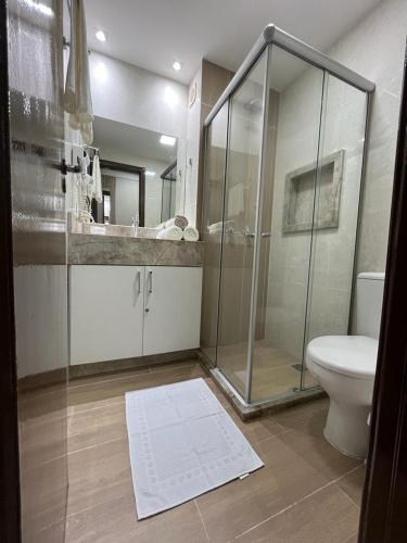 a bathroom with a glass shower and a toilet at Ponta Negra Beach Apt 507 in Natal