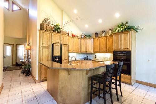 a kitchen with wooden cabinets and a island with bar stools at Interlachen Unit 4 in Nisswa