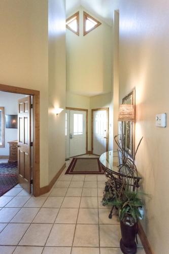 a living room with a table and a hallway at Interlachen Unit 4 in Nisswa