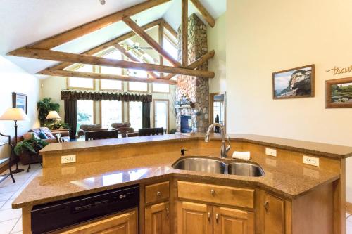 a kitchen with a sink and a living room at Interlachen Unit 4 in Nisswa