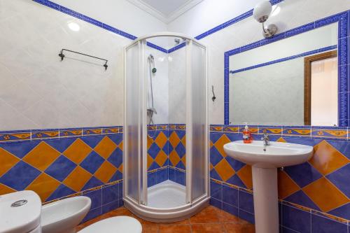 ein Badezimmer mit Dusche und Waschbecken in der Unterkunft Casa de Teones con piscina privada in Montecorto