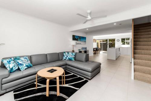 a living room with a couch and a table at BARBADOS Ultimate Laid-back Holiday - Flat Stroll to River in Noosaville