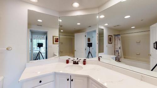 a bathroom with a sink and a large mirror at 5506 Hampton Place South in Hilton Head Island