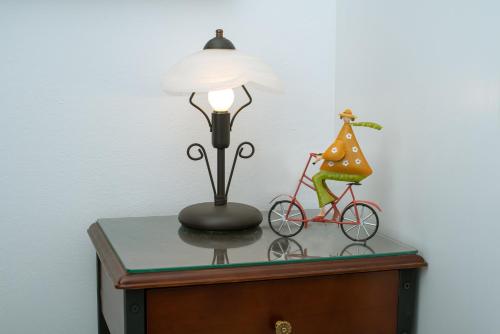 a lamp and a bike on a table at Haris Villas in Keratokampos