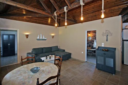 a living room with a table and a couch at Efi's Home in Vourvourou