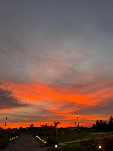 a road with a sunset in the sky at Days Inn Zarate in Zárate