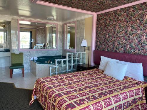 a hotel room with a bed and a bath tub at Downbeach Inn in Atlantic City