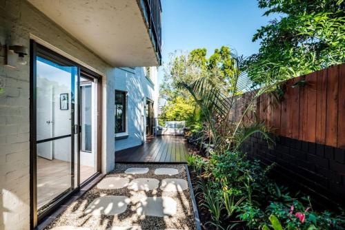 a porch of a home with a sliding glass door at 16KAT Holiday Noosa Style, Great location, Pet Friendly in Noosa Heads