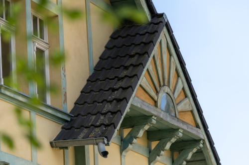 a black roof on the side of a building at Vila Heide in Česká Kamenice