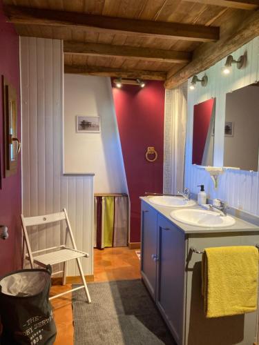 a bathroom with a sink and a mirror at L'Orée des Mages - Ma maison de vacances in Saint-Julien-de-Cassagnas