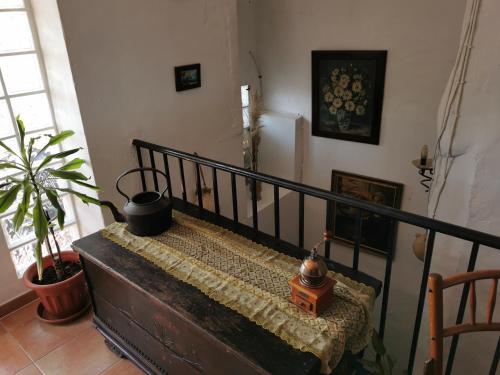 a stair railing with a table and a plant at Casa Rural l'Avia Tica in Benisuera