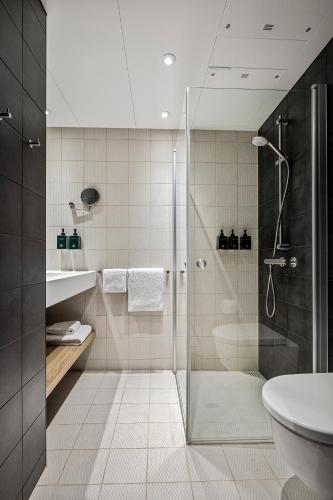 a bathroom with a shower and a toilet and a sink at Lily Country Club in Klofta