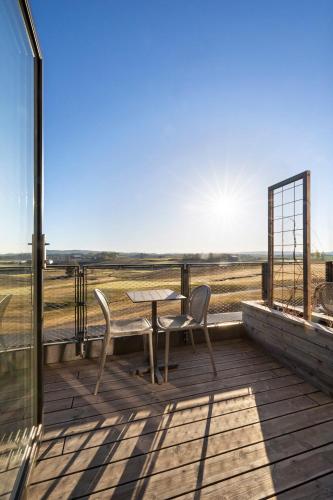 a wooden deck with a table and two chairs on it at Lily Country Club in Klofta