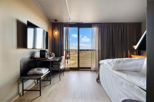 a hotel room with a bed and a desk with a computer at Lily Country Club in Klofta
