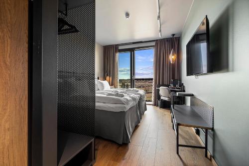 a hotel room with a bed and a window at Lily Country Club in Klofta