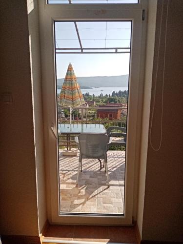 a door to a patio with a view of a table at Apartmani Bosco in Tivat