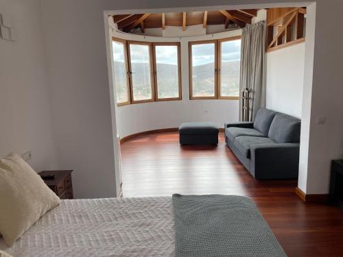 a living room with a bed and a couch at Villa Neila, Fuerteventura in Tarajalejo