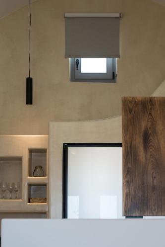a view of a kitchen with a window and a microwave at Elements Cozy Suites Pyrgos in Pirgos