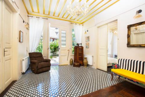 a living room with a chair and a chandelier at No16 Ada in Adalar